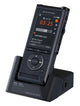 OM System dictaphone sitting in docking station