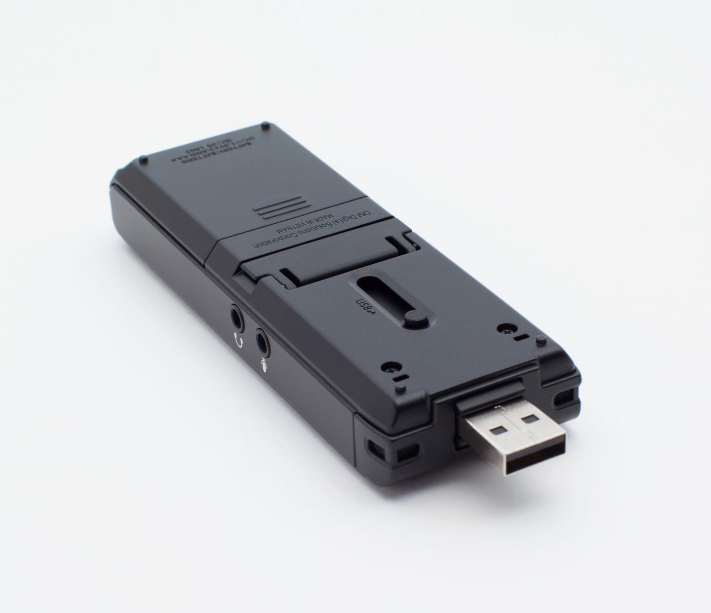 Back view of WS-883, sitting flat on a surface, showing battery cover, slide out usb connector and audio jacks on the side for microphone and headset