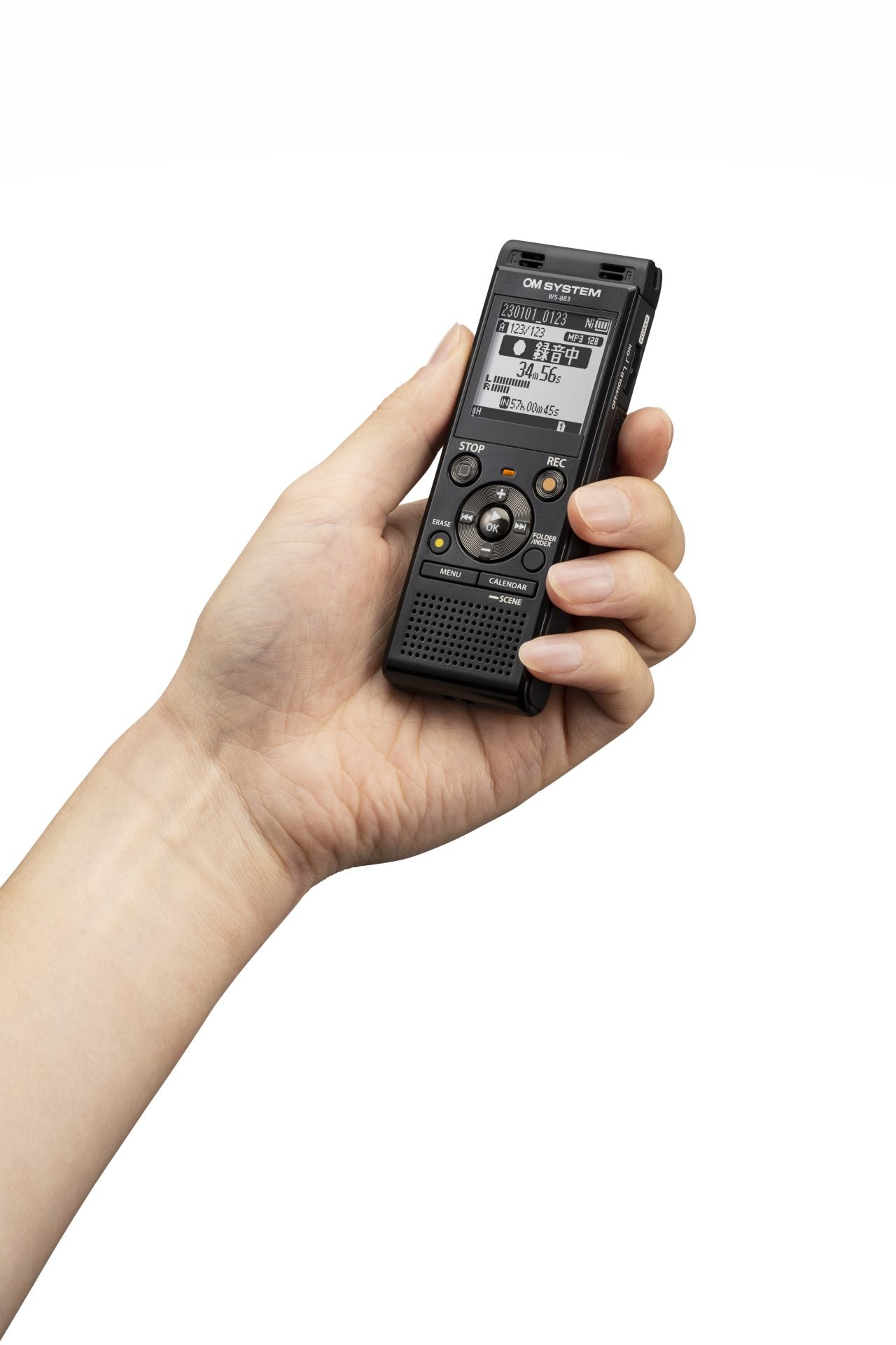 Hand holding OM System WS-883 digital recorder, showing that the recorder is smaller than an average hand
