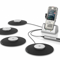 A Philips DPM8900 Conference Recorder with a digital display, connected to a series of black circular microphones - LFH 9172, designed for capturing audio in a meeting setting.