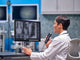 Radiologist  examining X rays and dictating into hand held OM System RecMic RM-4010N