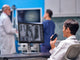 Radiologist recording notes, while examining x-rays, on OM System DS-9100 dictaphone