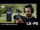 Man with headphones using Olympus video camera with OS-P5 recorder attached for recording audio and visual